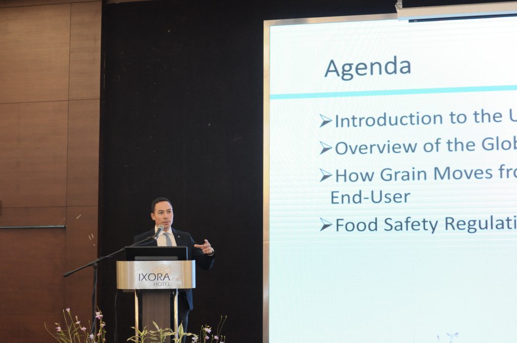 Man Presenting Agenda Slide at Podium