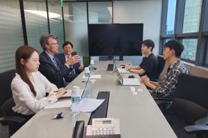 Two groups of people talking across a table
