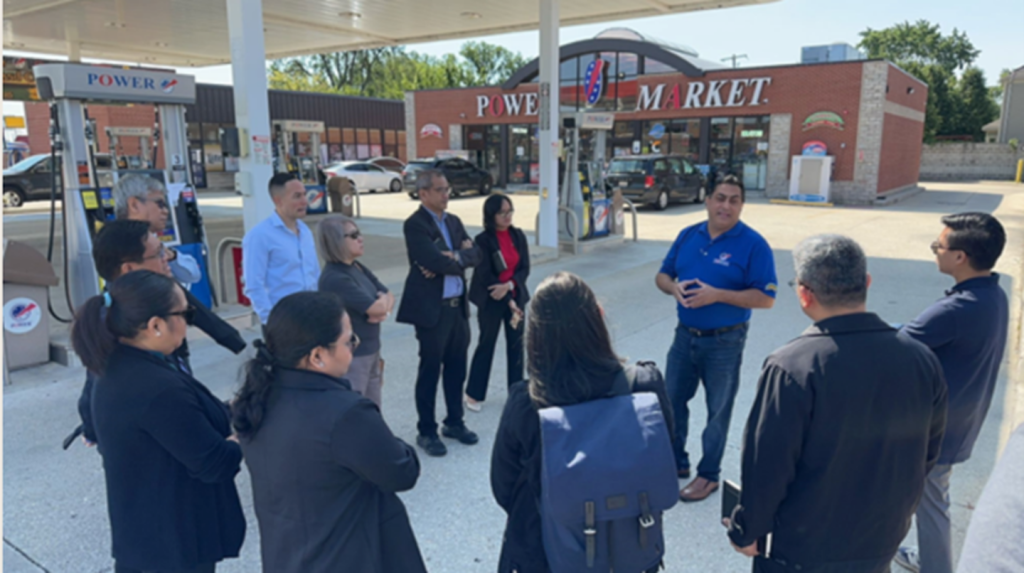Representatives from the Philippines National Biofuels Board, the chief cross-department policymaking body for ethanol in the Philippines, inspect a blender fuel dispenser offering E10, E20 and E30 fuel blends in Elmhurst, Illinois, in August 2024.